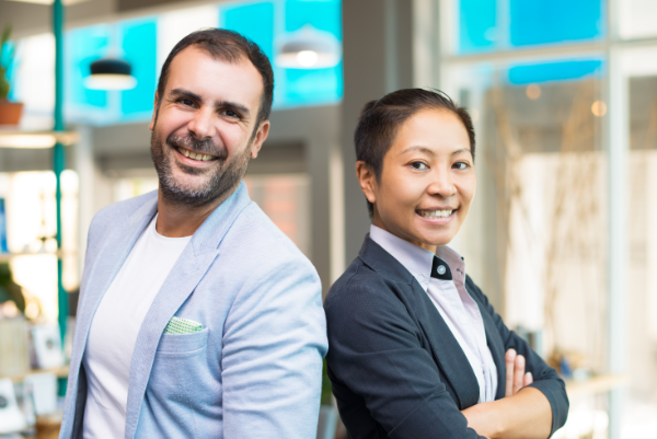 happy asian latin managers smiling standing side by side